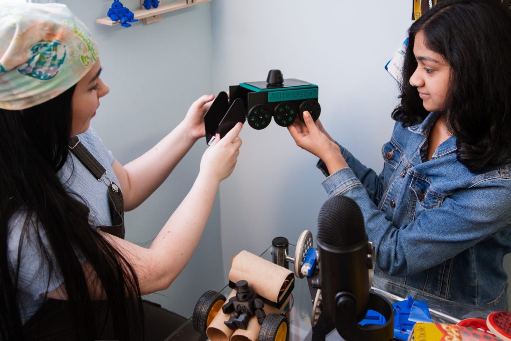 Danielle Boyer and Vinaya Gunasekar with Auto Oscar robot