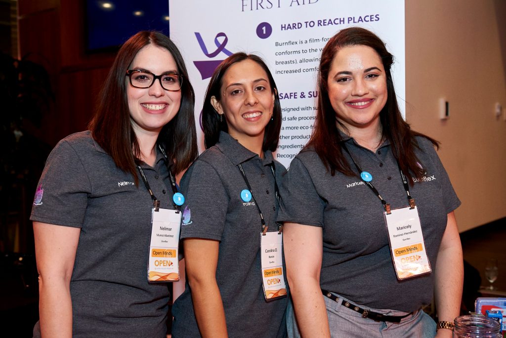 Three women at a conference.