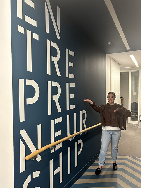 Kendra Batchelder of Waved Medical at the Jacobs Technion-Cornell Institute at Cornell Tech, pointing to a wall with the word “Entrepreneurship” written on it.